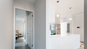 A modern kitchen with a white countertop and stainless steel appliances. - Casa Love 1D (Panama City)