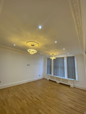 Enjoy a spacious room with a high ceiling and large window offering a view.