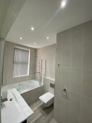 Jetted bath, hair dryer, towels, soap