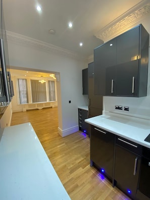 Enjoy cooking in this well-lit kitchen with sleek cabinetry and a spacious dining area.