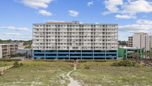 A multi-story hotel with a parking garage below.
