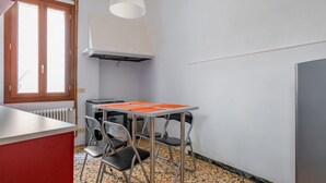 A compact kitchen with a table, chairs, a radiator, and a window. - GuestHost - Apartment located on the first floor of an ancient building without a lift.Splendid view of the canal from where the typical Venetian gondolas pass.It accommodates 4 people in 85 square meters of space with two double bedrooms.We are located  (Venezia)