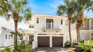 A two-story house with a front porch, a balcony, and a garage.