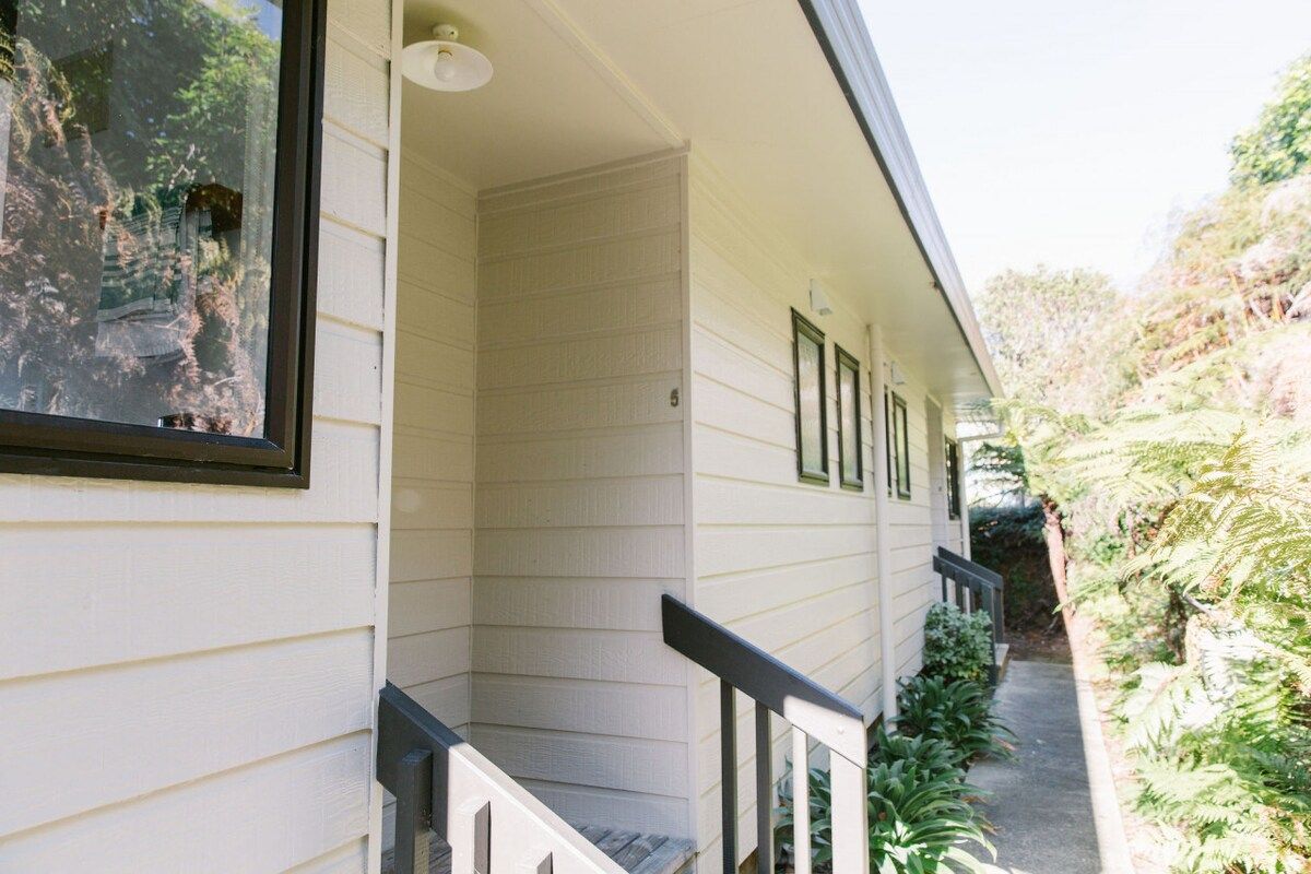 A house with a covered porch, a window, and a door.