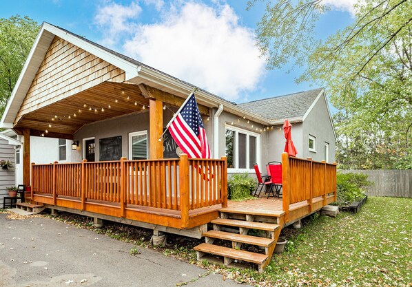 A house with a wooden deck, an American flag, and a red umbrella. - 6bd 3ba large gathering home, close to YMCA and 5 miles to Downtown Duluth (Hermantown)