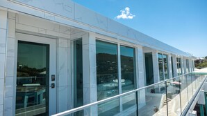 A modern building with large glass windows and a reflective exterior. - Dolphin Suites  (St. John)