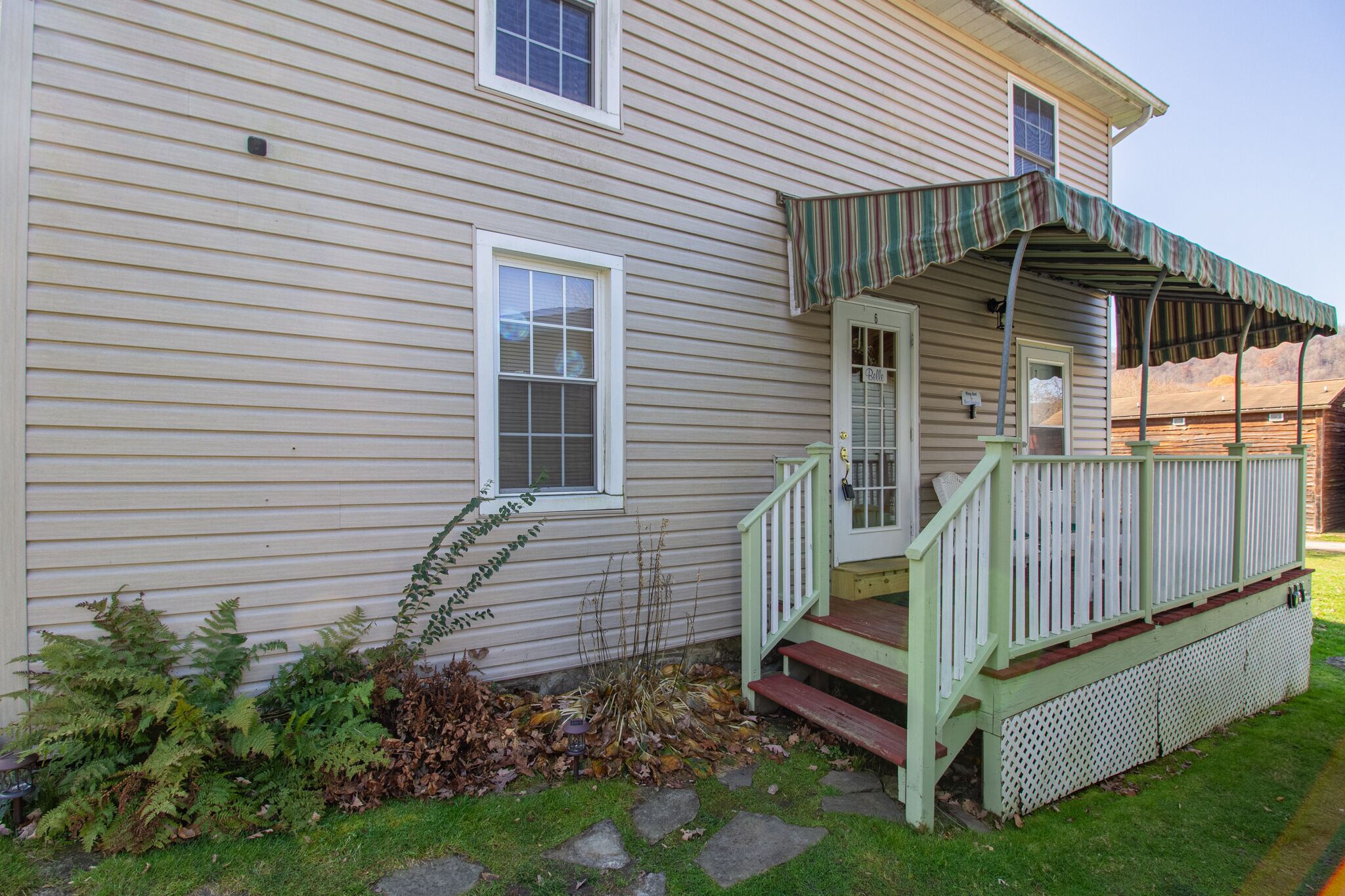 A house with a porch, a front door, and a mailbox.