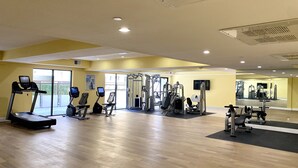 A gym with treadmills, elliptical machines, and weight machines.