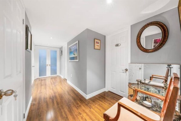 Enter a hallway with a polished floor, leading to a door marked 'WC' and a traditional door with a set of keys.