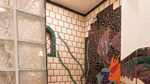 A bathroom with mosaic tiles, a glass shower enclosure, and a tiled floor. - Marina Pinacate Remodeled 3 Bedroom 2 Bath Overlooking Sea of Cortez Views (Puerto Penasco)