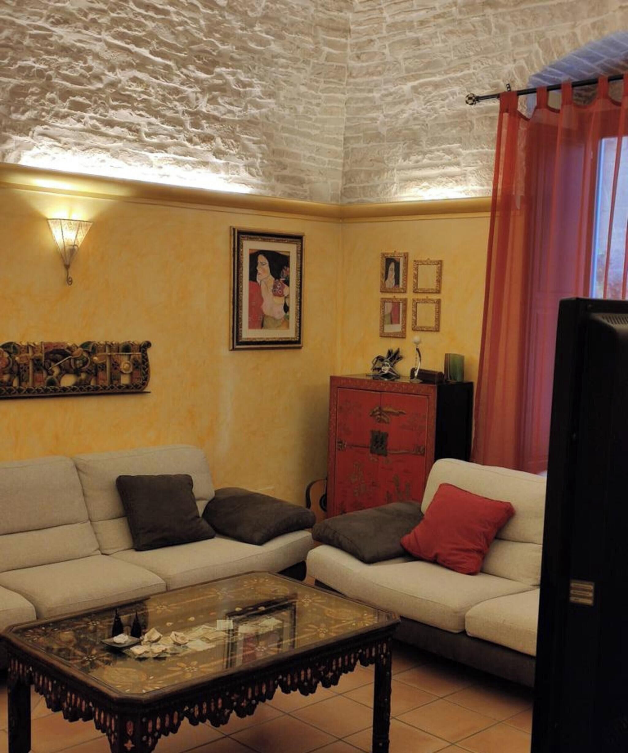 A living room with a sofa, a coffee table, a cabinet, and a wall-mounted picture.