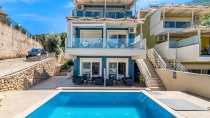 A multi-story building with a swimming pool, outdoor seating, and a staircase. - Apartment 'Oceanida Aelia Room 2' with Shared Pool and Wi-Fi (Nikiana)