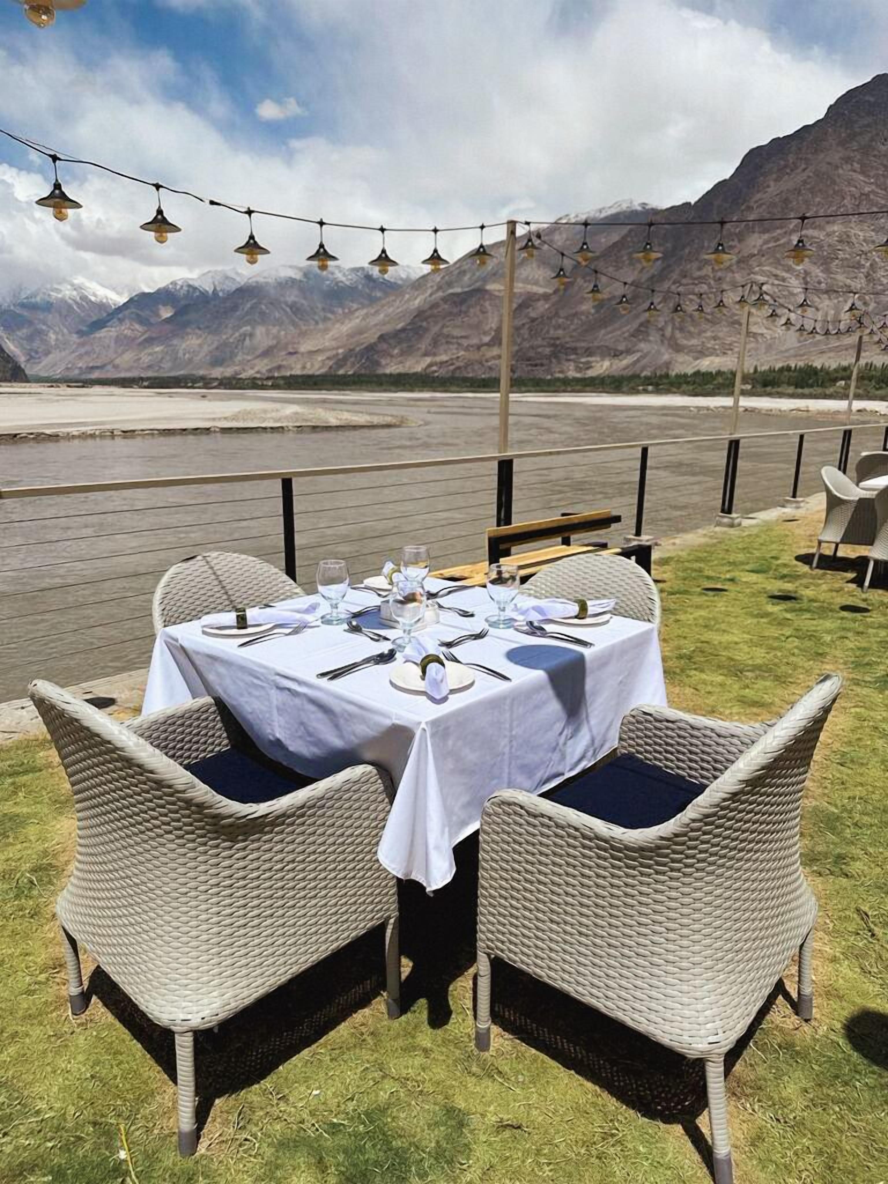 A table set outdoors with a mountain view.