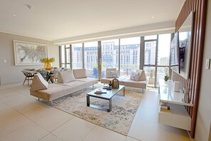 Luxury Penthouse, 2 Bedrooms, City View, Tower | Living area | 65-inch Smart TV with satellite channels - Azalia Apartments (Sandton)