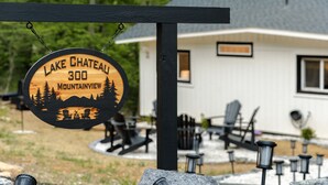 A wooden sign with "Lake Chateau 300 Mountainview" and a mountain scene. - Lake-view! Hot Tub! Fire Pit. Grill. Game Room. King bed. (Luray)