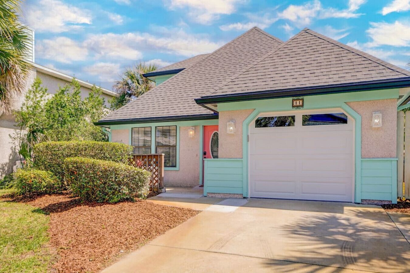 A single-story house with a garage, a front porch, and a well-maintained lawn.