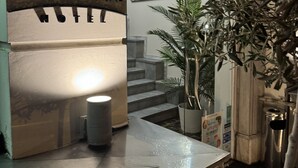 A hotel reception area with a sign reading "ILISIA HOTEL" and a staircase leading to the upper floor. - HOTEL ILISIA (Thessaloniki)