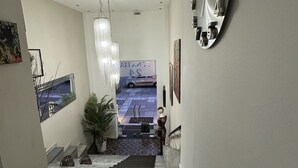 A modern interior with a staircase leading to a car parked outside. - HOTEL ILISIA (Thessaloniki)