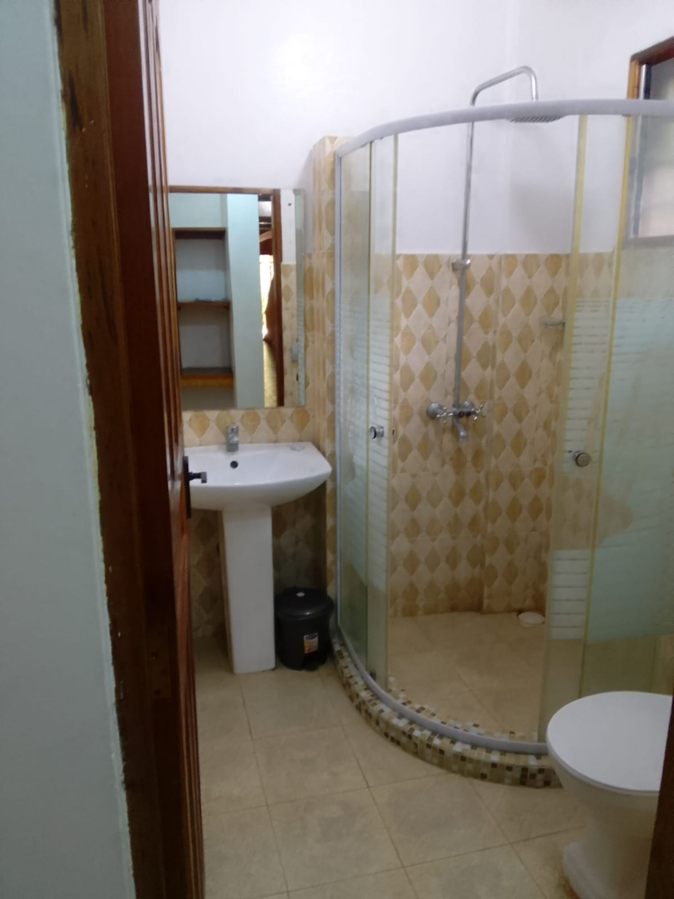 Un baño con lavabo, inodoro y cabina de ducha.