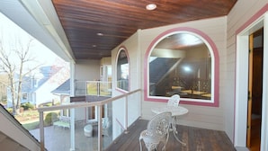 A covered porch with a wooden ceiling, white railings, and a table with chairs. - Redbud Keep - move theater, wifi, golf, view, recreation center access, grill (Hedgesville)