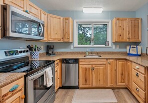 Kitchen opens up to the dining area and has large windows to let the natural light in.