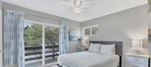 The cozy main bedroom located upstairs includes access to a private balcony to enjoy your morning coffee and watch the many bird species that call the Texas Hill Country home!