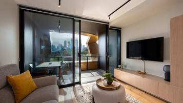 Basic Apartment, Multiple Beds | Living area | TV