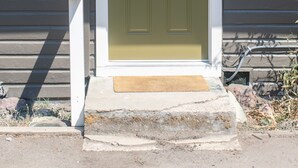 A front door with a mailbox and a number '4' on the wall. - Enjoy the tranquility of a scenic riverside neighborhood in Gold Hill. This area is peaceful, offers beautiful views, and is a convenient stopover location. (Gold Hill)