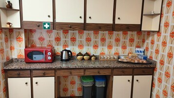 Mini-fridge, microwave, oven, cookware/dishes/utensils