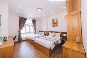 Deluxe Quadruple Room | Premium bedding, down comforters, Select Comfort beds, desk