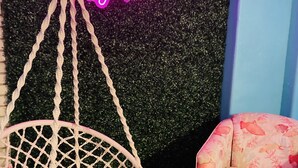 A hanging chair with a netted frame and a neon sign above it that reads "Castaway Staycation". - Spacious 3BR Brick Home, Sleeps 7❤️Free Parking❤️No Pet Fee❤️No Extra Guest Fee🏖️ (Texas City)