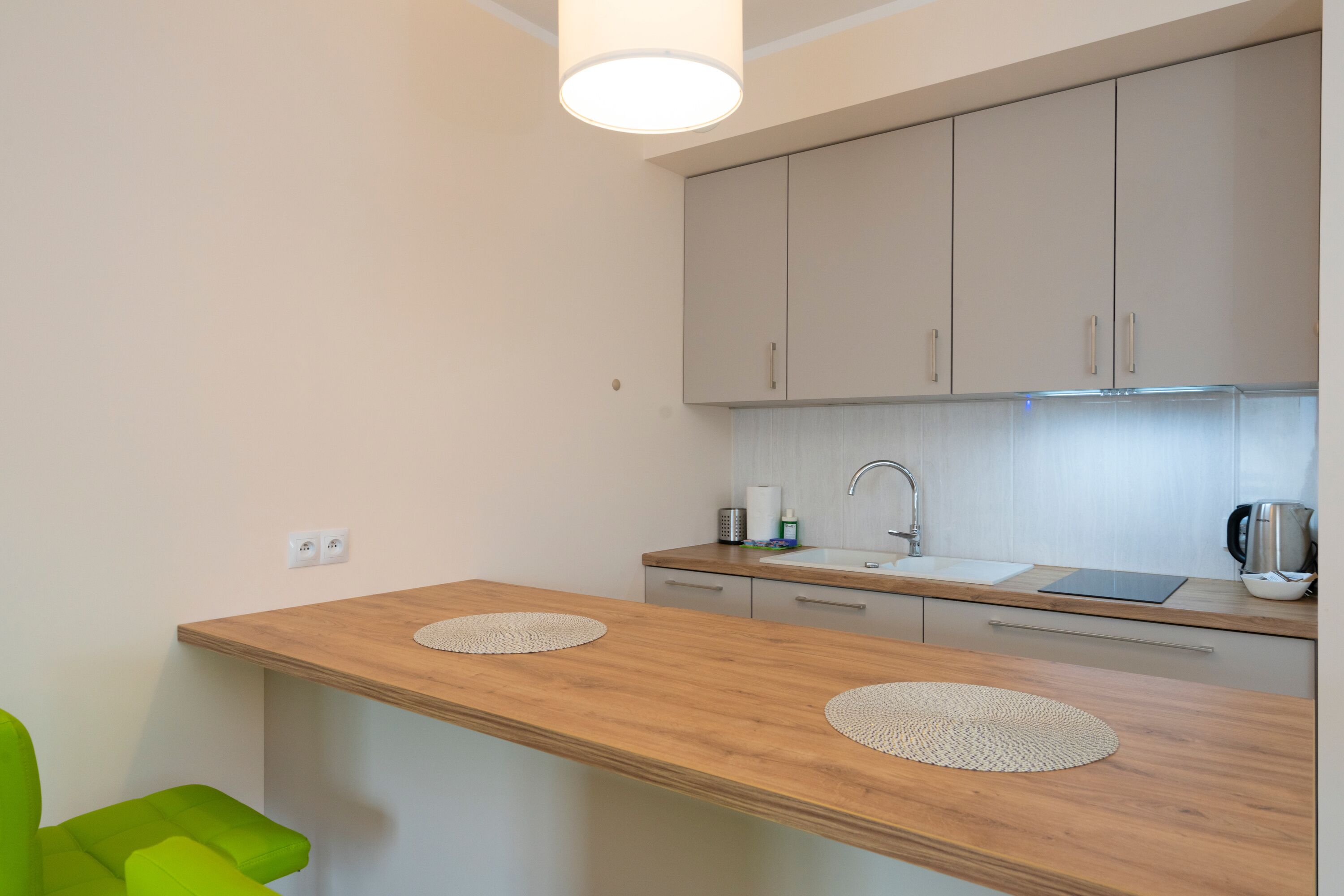 A modern kitchen with wooden countertops, a built-in sink, and cabinets.