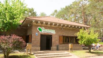 A brick building with a tiled roof and a sign reading "Bar-Restaurante 'El Pantano'".