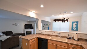 A modern kitchen with wooden cabinets, a dishwasher, and a granite countertop.