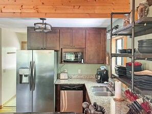 A kitchen with a stainless steel refrigerator, a microwave, and a sink. - Free rafting and zip line tix - convenient Nantahala Gorge location sleeps 10 (Bryson City)