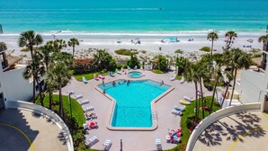 A resort with a pool, beach, and palm trees. - NEW! Luxuriously Updated & Renovated Beachfront Retreat- Walkable to Fun!! (Madeira Beach)