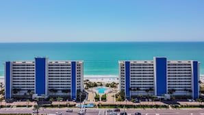 A hotel with a pool, beach view, and parking lot. - NEW! Luxuriously Updated & Renovated Beachfront Retreat- Walkable to Fun!! (Madeira Beach)
