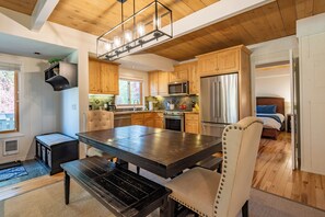 A modern kitchen with wooden cabinets, stainless steel appliances, and a central island.