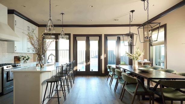A modern kitchen with a central island, bar stools, and pendant lighting. - Chic, Marigny Retreat | Heated Pool (New Orleans)
