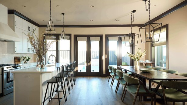A modern kitchen with a central island, bar stools, and pendant lighting. - Chic, Marigny Retreat | Heated Pool (New Orleans)
