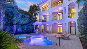 A multi-story building with a pool, outdoor seating, and a covered patio area. - Gulf Views | Pool | Close to Beach | Elevator (Santa Rosa Beach)