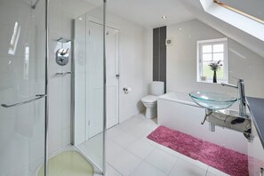 Bathtub, hair dryer, towels, toilet paper