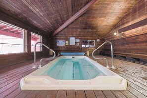 Relax in a hot tub with a bench and safety handrails.