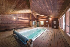 Relax by the rectangular pool surrounded by a wooden deck.