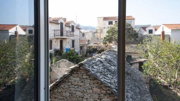 Vista de una zona residencial con edificios de piedra y tejados de tejas.