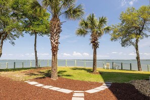 Stroll along the waterfront promenade, lined with palm trees and offering a clear view of the lake.