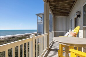 Enjoy breathtaking ocean views from this property's balcony, featuring a table and chair.