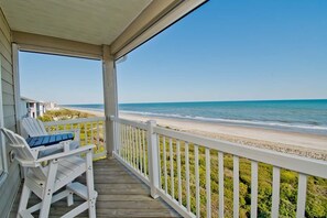 A wooden deck with white railings overlooking a beach. - Ocean Club G301, Oceanfront Condo in Indian Beach, NC! (Indian Beach)