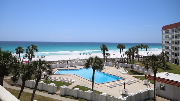 A resort with a pool, beach view, palm trees, and a building with balconies. - 346 El Matador 2 Bedroom Home by RedAwning (Fort Walton Beach)