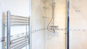A glass-enclosed shower with a handheld showerhead and a wall-mounted control panel. - 4 Bedroom-southampton-sleeps 6- Garden (Southampton)